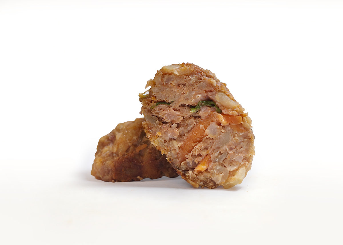 Closeup of a meatball with meat, veggies, and carrots for dogs