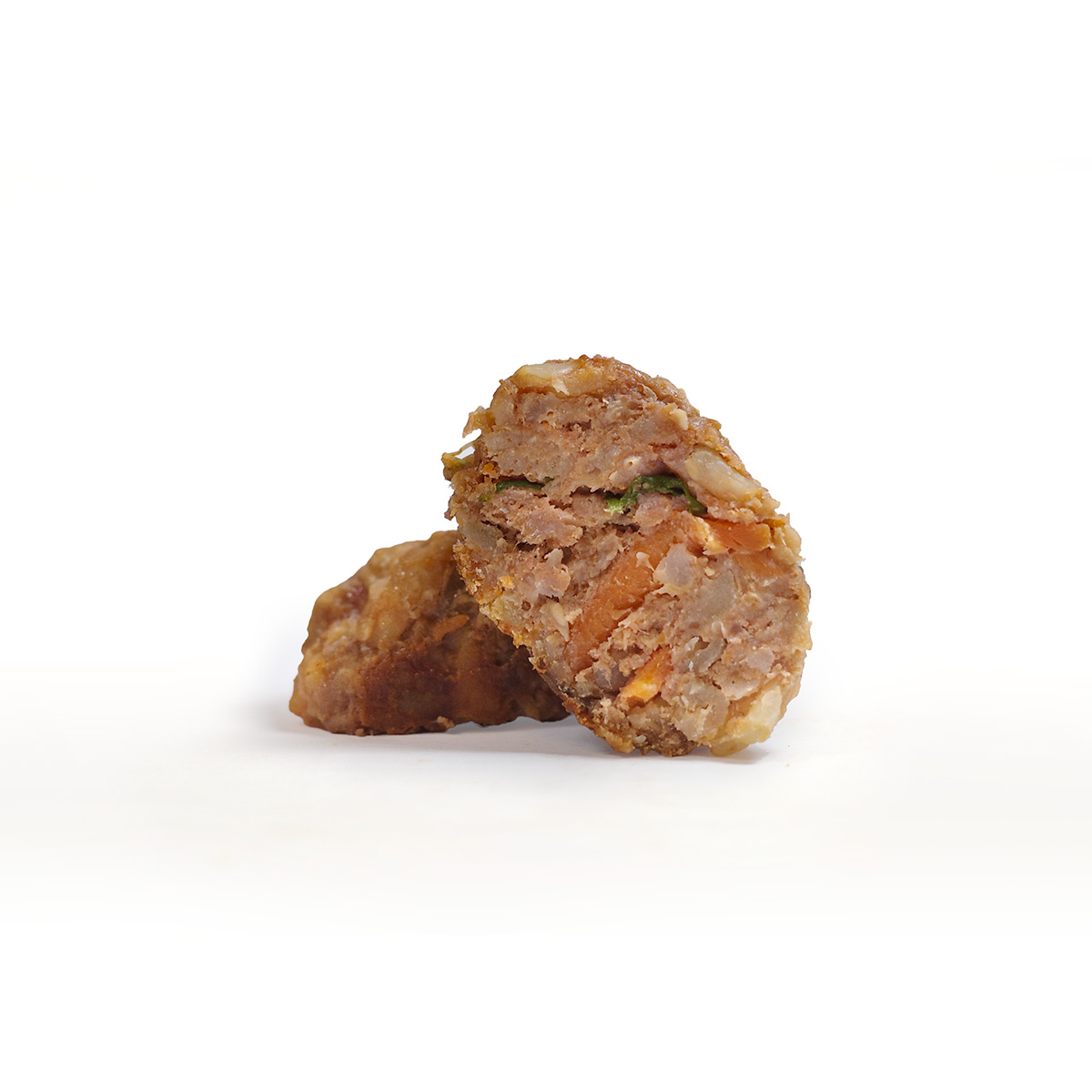 Closeup of a meatball with meat, veggies, and carrots for dogs
