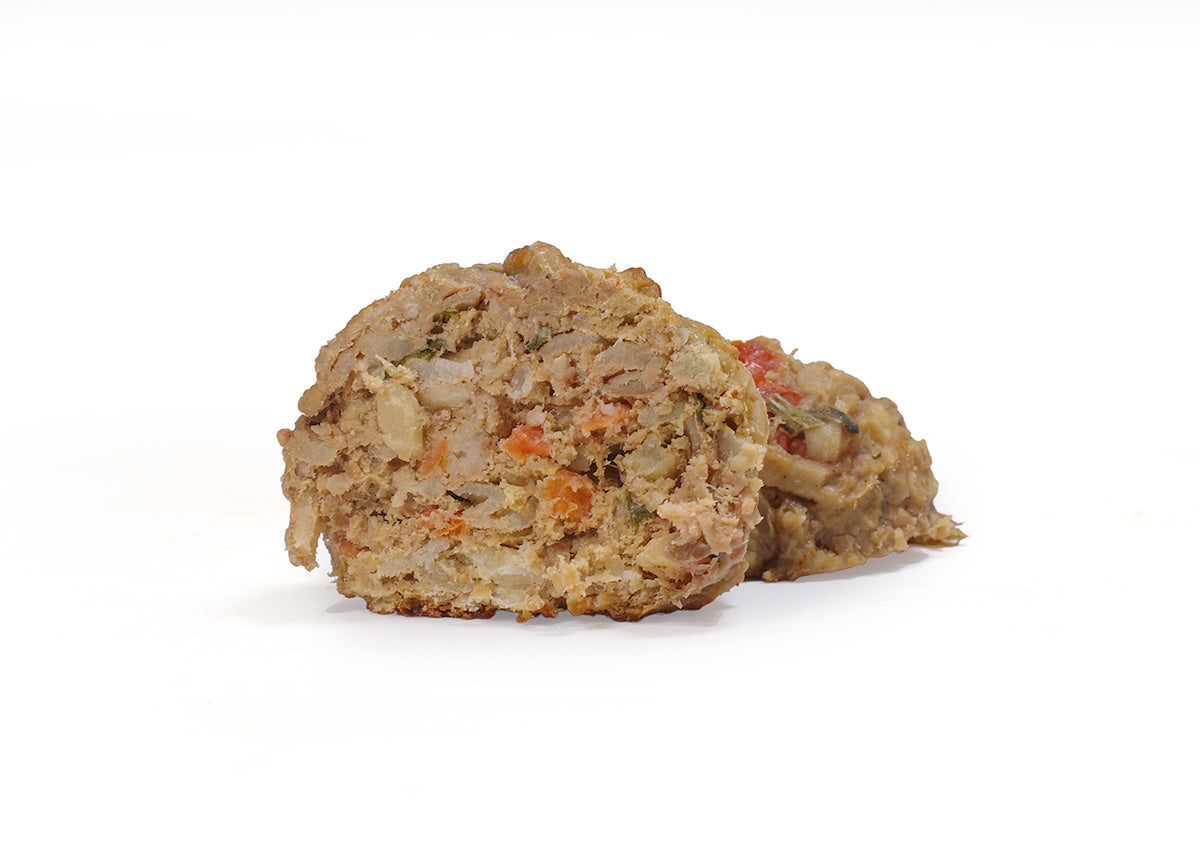 Closeup of turkey meatballs with fresh vegetables, fruit, and carrots for dogs
