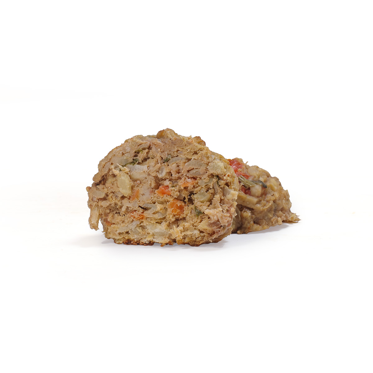 Closeup of turkey meatballs with fresh vegetables, fruit, and carrots for dogs